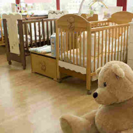 empty nursery with teddy bear on floor